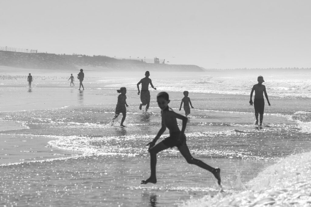 kids playing in waves